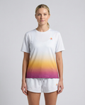 Woman wearing a white t-shirt with a colorful gradient design and matching shorts on a light gray background