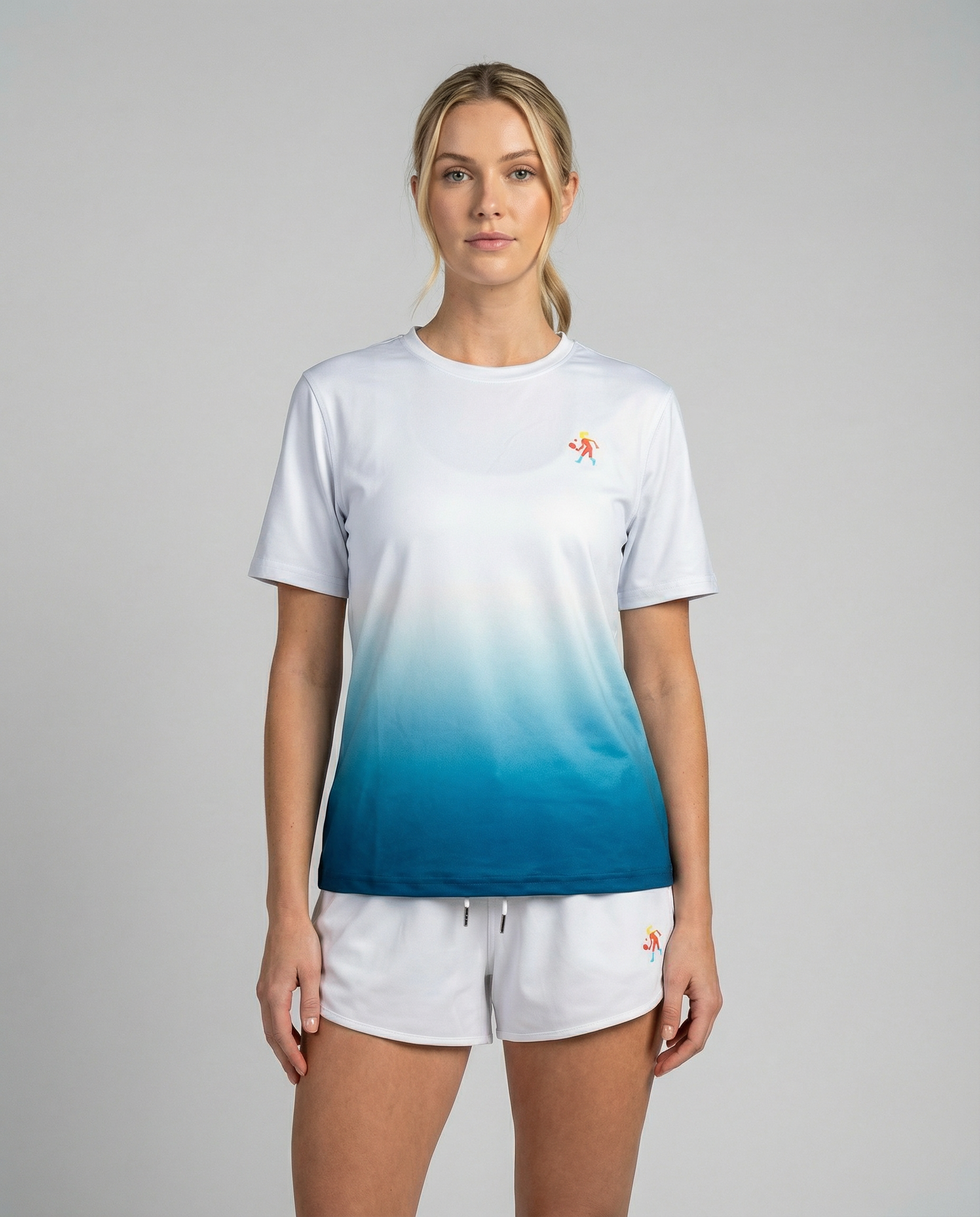 Woman wearing a white and blue gradient t-shirt with a logo on a gray background