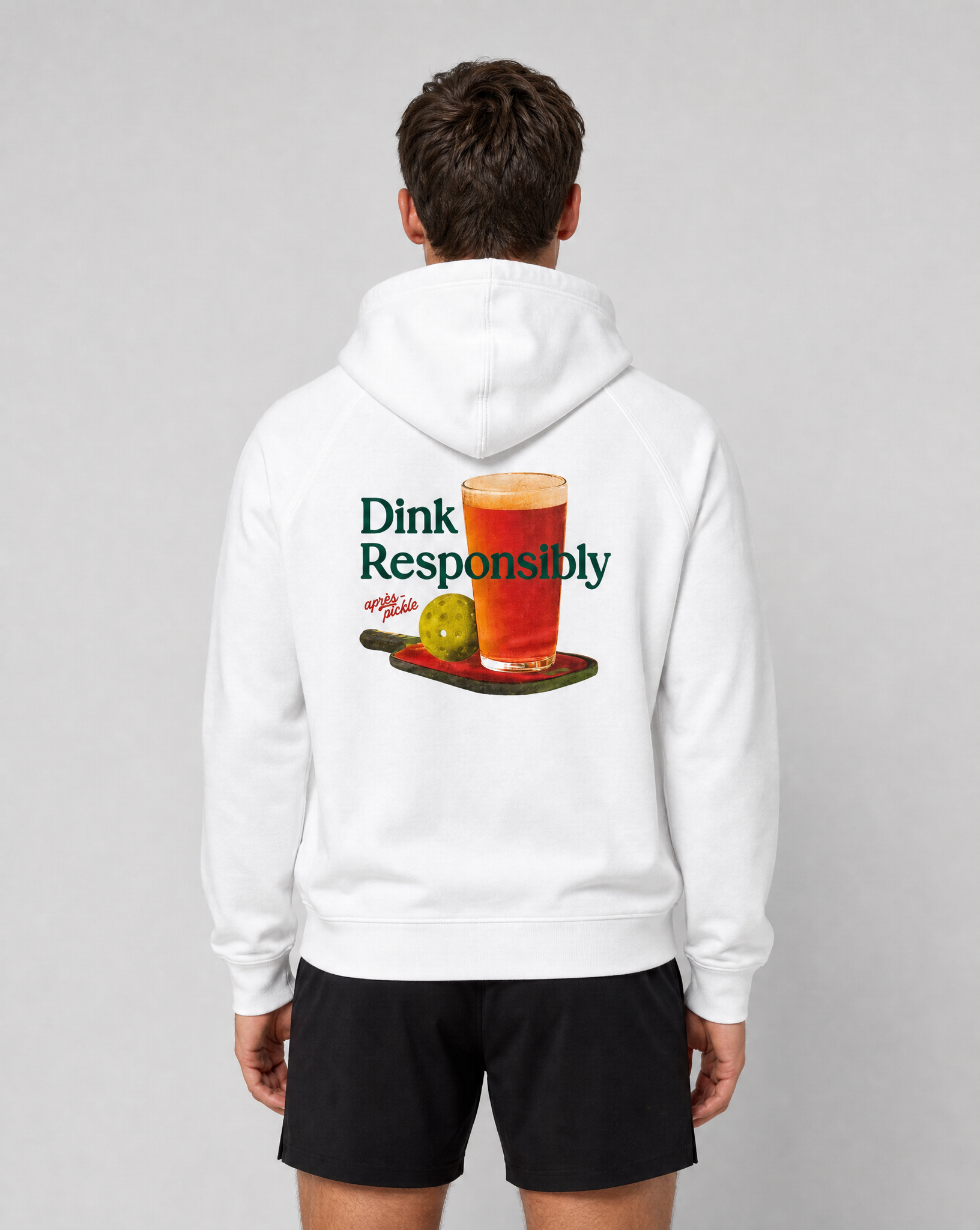 Person wearing a white hoodie with a graphic and text on the back, standing against a plain background.