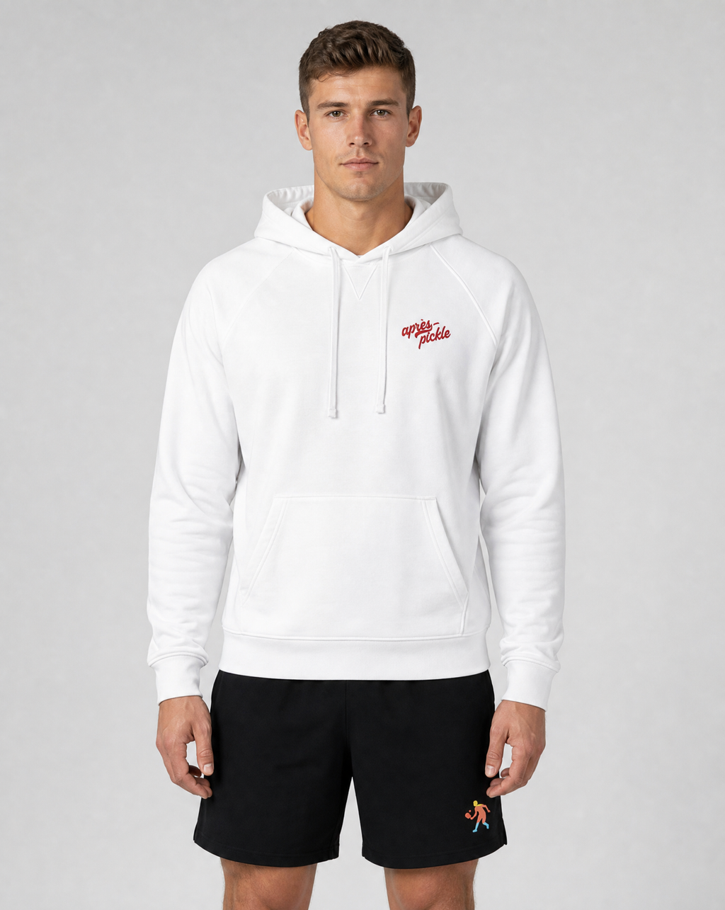 Man wearing a white hoodie with red text and black shorts on a gray background