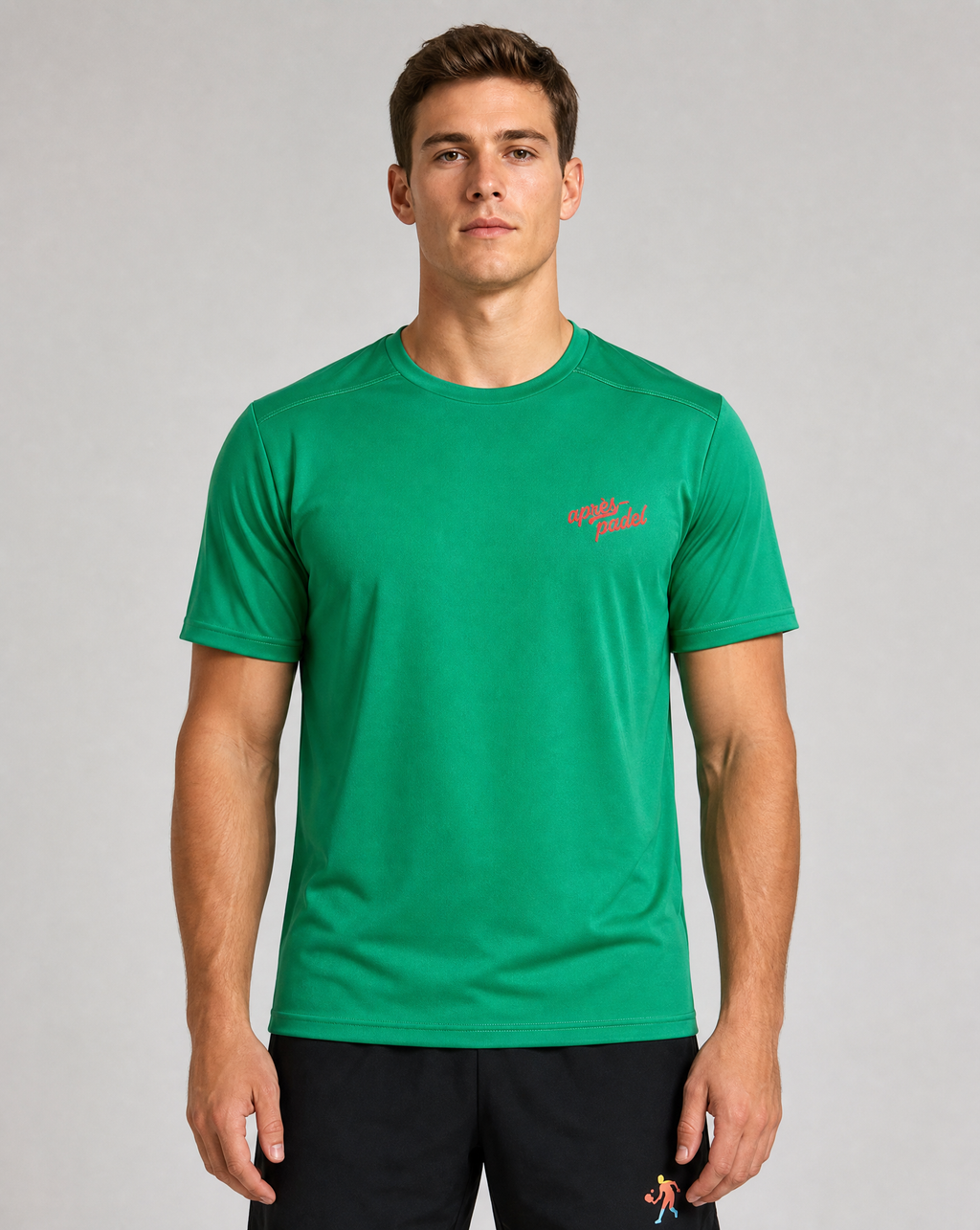 Man wearing a green t-shirt with a red logo on a gray background