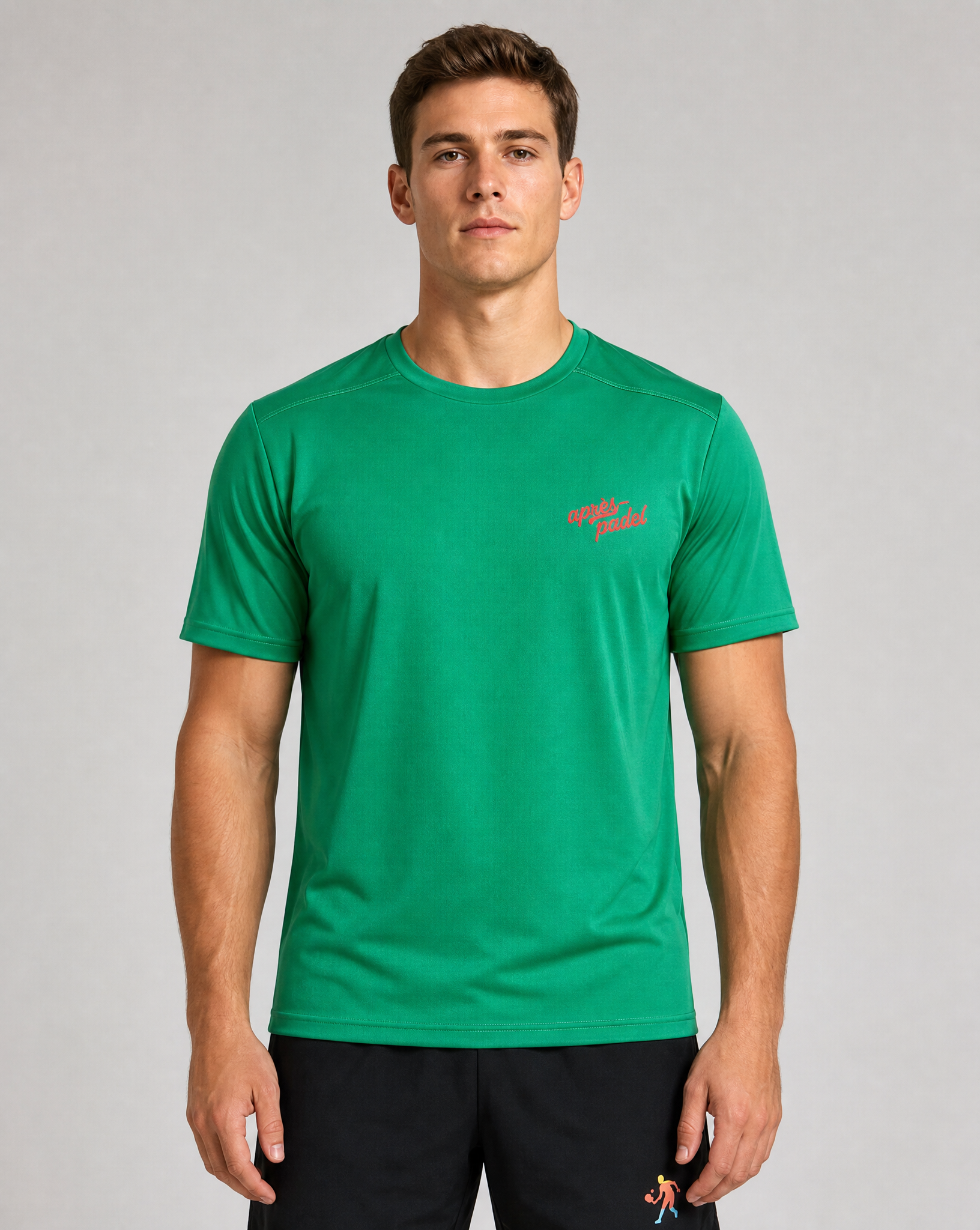 Man wearing a green t-shirt with a red logo on a gray background